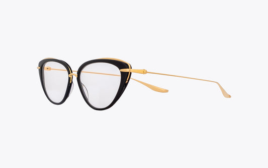 Three quarters view: cat-eye eyeglasses with black-gold frames on a off-white background