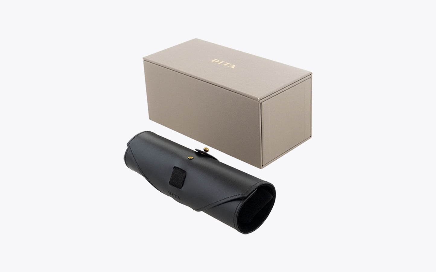 Black monocular and beige box on a white background for Dita Tessel DTX 118 gold black eyeglasses