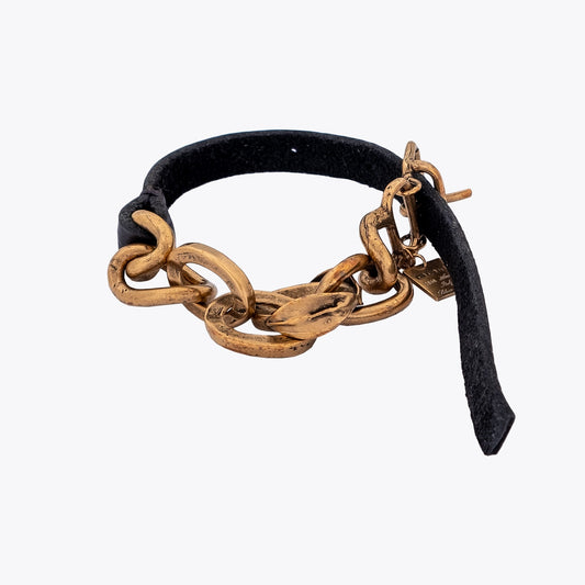 Bracelet with gold plated silver cable chain and black leather strap on a white background