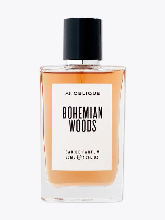 A clear glass bottle of Atl. Oblique Bohemian Woods EDP with a black cap and a label showing the fragrance name and the fact that it is an Eau de Parfum, 50ml.