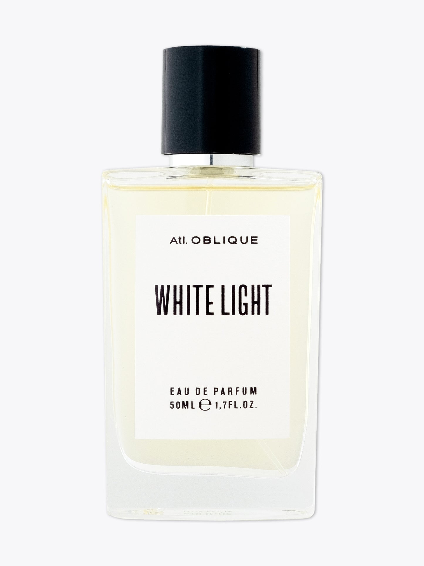 Perfume bottle labeled 'White Light' by Atl. Oblique on a white background