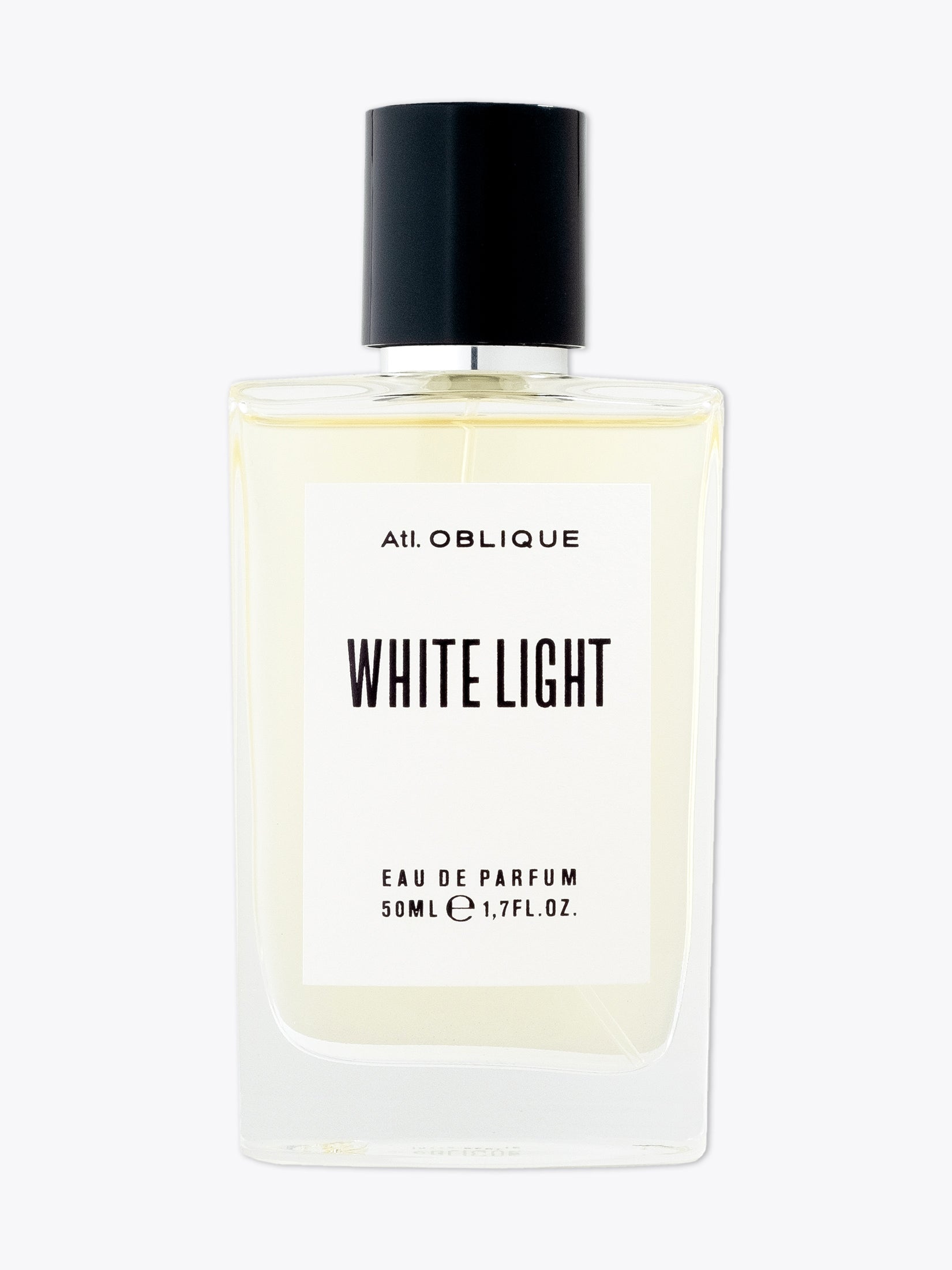 Perfume bottle labeled 'White Light' by Atl. Oblique on a white background