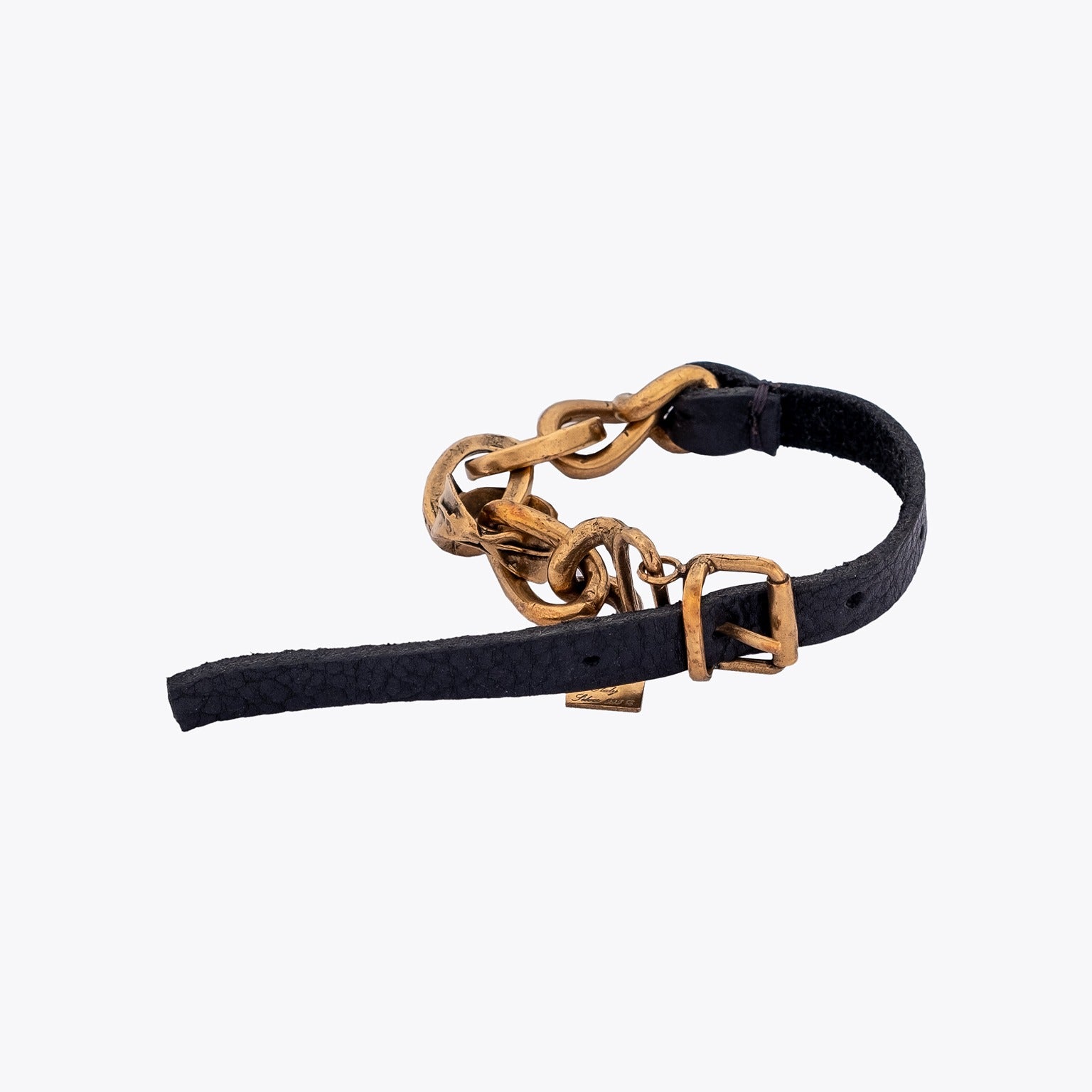 Black leather belt with gold plated silver cable chain detailing on a white background